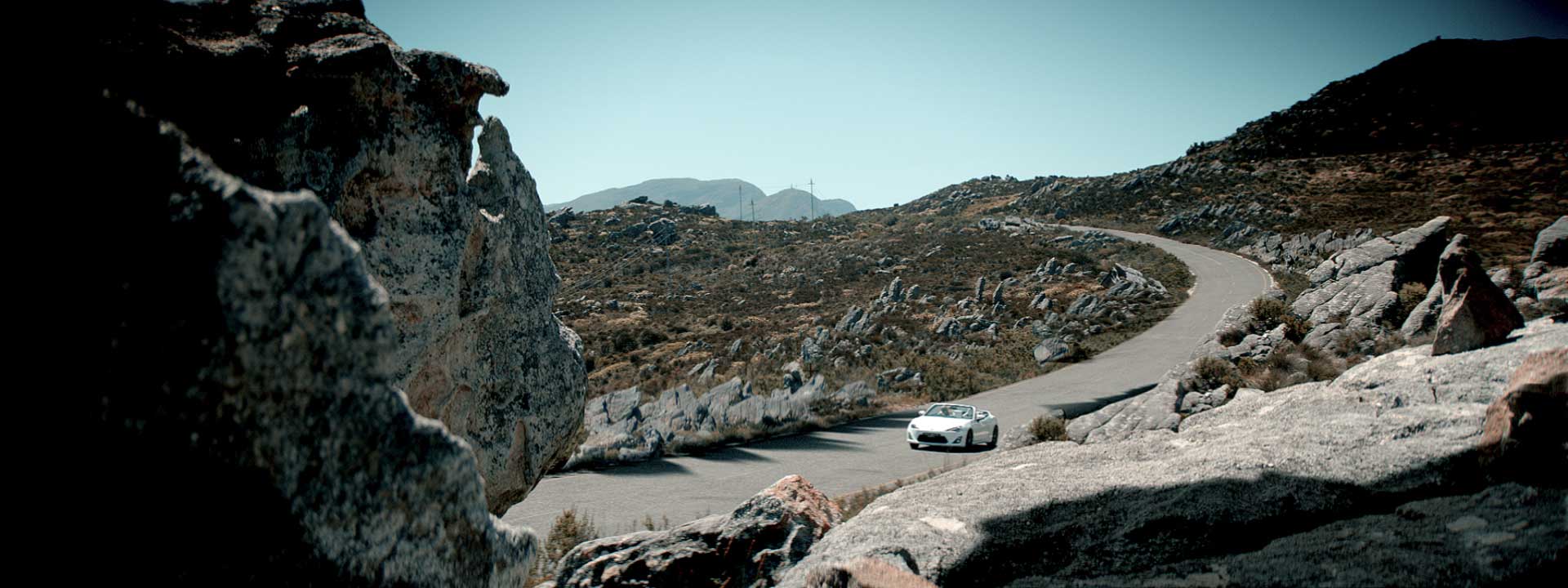 Driving car between hills. Still  Toyota FT-86 open – Commercial